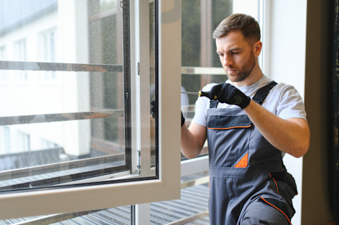 Handyman repairing window