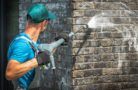 A man washing a house