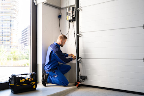 man repairing a garage door 