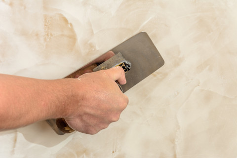 Finishing venetian plaster on a wall
