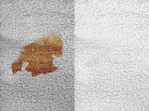 A carpet with a stain, and a clean carpet next to it
