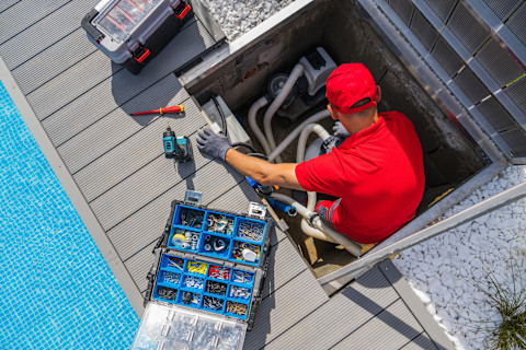 Technician maintaining pool equipment