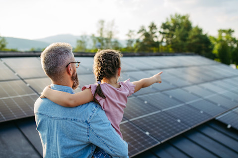 A family looking at solar panels.