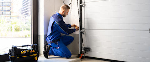 A man is checking over a new garage door.