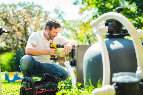 Electrician works on pool heater