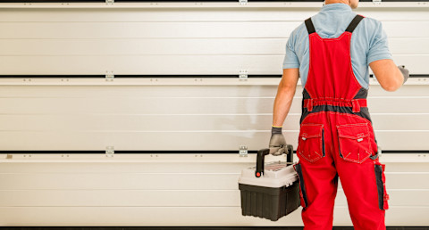 A man is checking out a new garage door