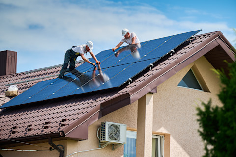 workers installing solar panels